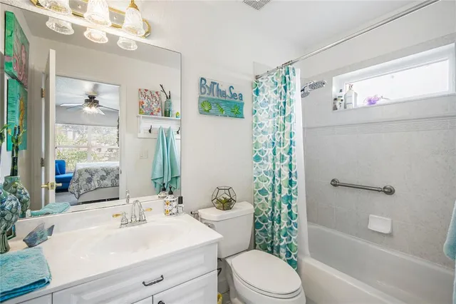 a bathroom with a sink a toilet a tub and shower