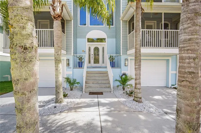 a view of a brick house with plants and entryway