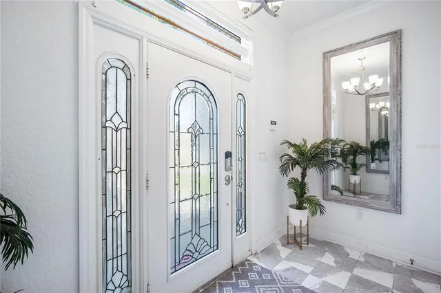 a view of front door with potted plants