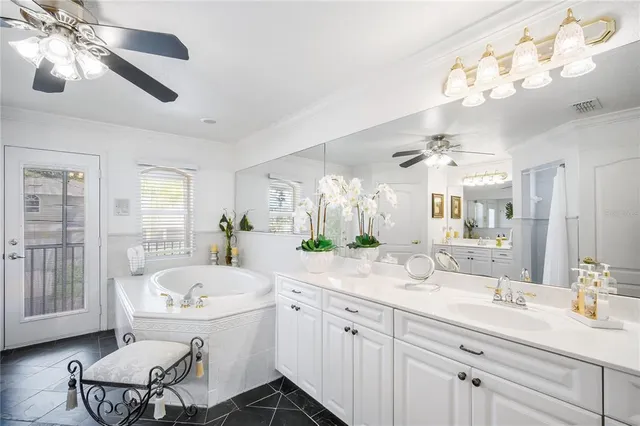 a bathroom with a tub sink and mirror