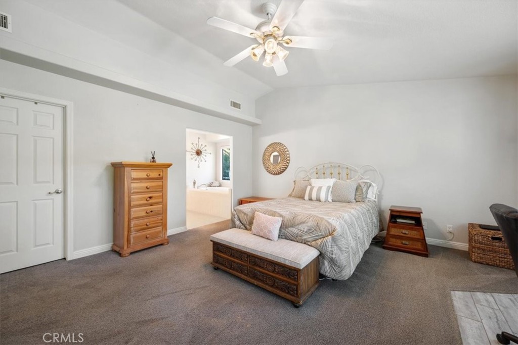 11625 Cenegal Road Atascadero, CA 93422 - Photo 12 of 54 a spacious bedroom with a bed and a chandelier