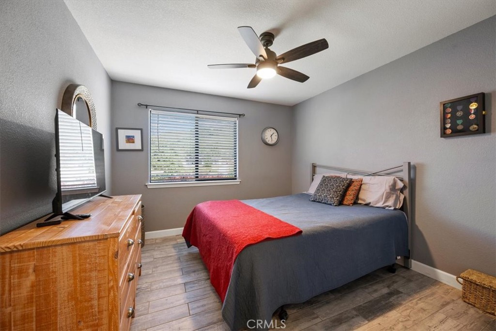 11625 Cenegal Road Atascadero, CA 93422 - Photo 22 of 54 a bedroom with a large bed and a flat screen tv