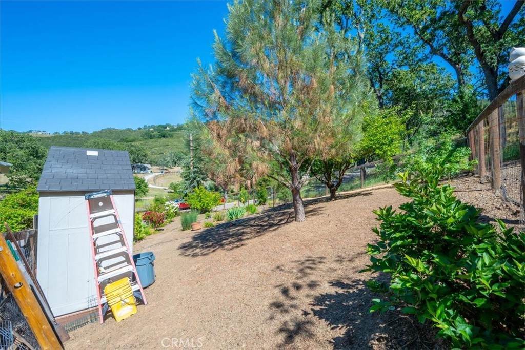 11625 Cenegal Road Atascadero, CA 93422 - Photo 38 of 54 a view of a street with potted plants and large trees