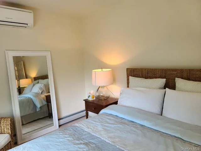 a bedroom with a bed and a mirror