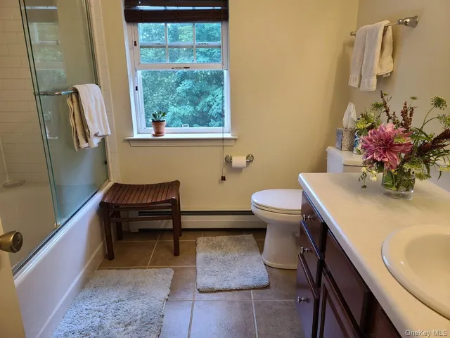 a bathroom with a sink toilet and a mirror