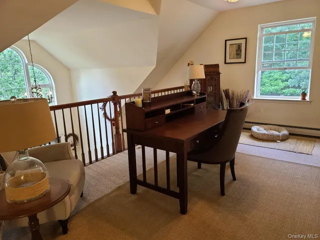 a view of a livingroom with furniture and a window