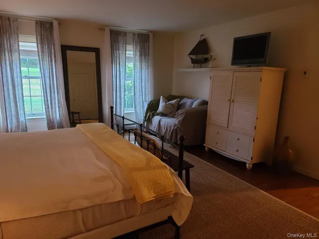 a bedroom with bed and window