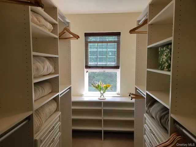 a view of room with window and cabinet