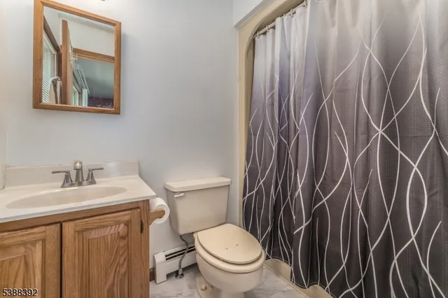 a white toilet sitting next to a bathroom sink