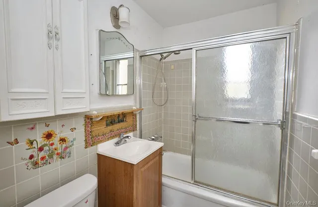 a bathroom with a shower toilet and sink