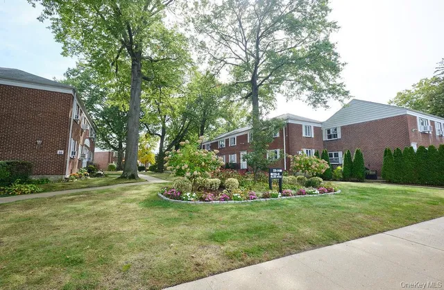 a view of a house with a yard and a garden