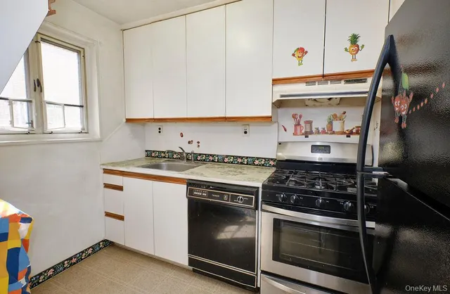 a kitchen with stainless steel appliances granite countertop a stove and a microwave