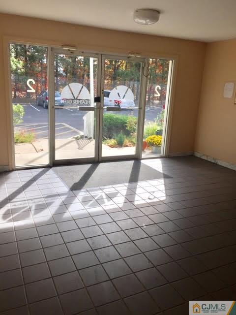 201 Raintree Court, Unit 201 Helmetta, NJ 08828 - Photo 3 of 20 a view of a livingroom with a floor to ceiling window and a yard