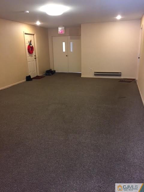 201 Raintree Court, Unit 201 Helmetta, NJ 08828 - Photo 4 of 20 an empty room with wooden floor and windows