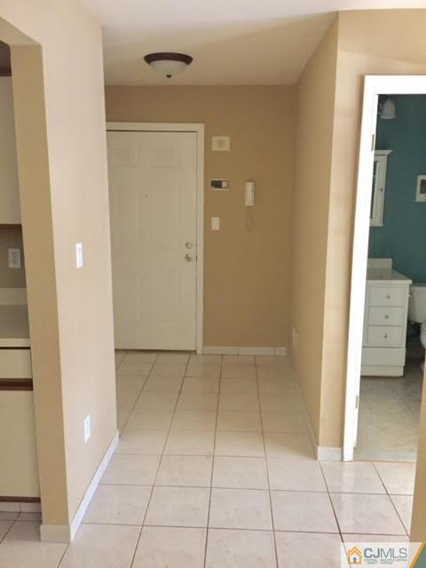 201 Raintree Court, Unit 201 Helmetta, NJ 08828 - Photo 6 of 20 a view of an empty room with a mirror