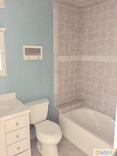 201 Raintree Court, Unit 201 Helmetta, NJ 08828 - Photo 7 of 20 a white toilet sitting next to a bath tub