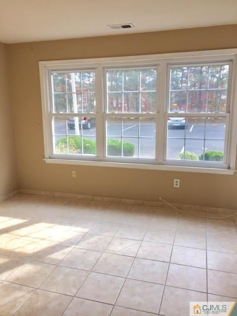 201 Raintree Court, Unit 201 Helmetta, NJ 08828 - Photo 8 of 20 a view of a windows and a kitchen with an empty room