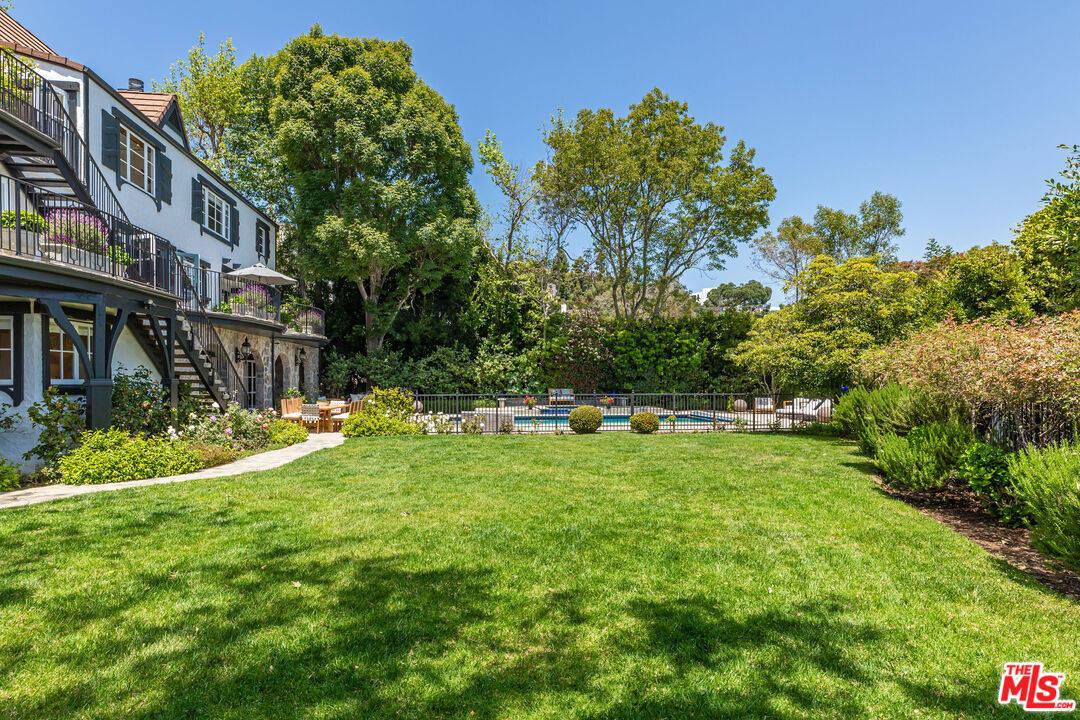 1756 Correa Way Los Angeles, CA 90049 - Photo 1 of 38 a backyard of a house with lots of green space