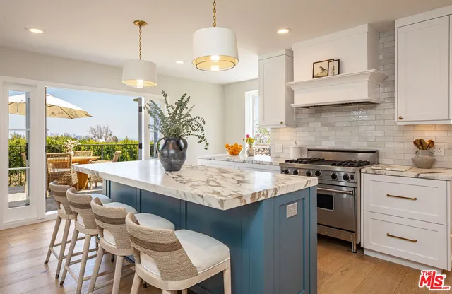 a kitchen with a table chairs stove and cabinets