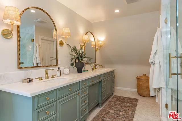 a bathroom with a double vanity sink and a mirror