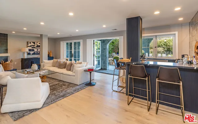 a living room with furniture and large windows