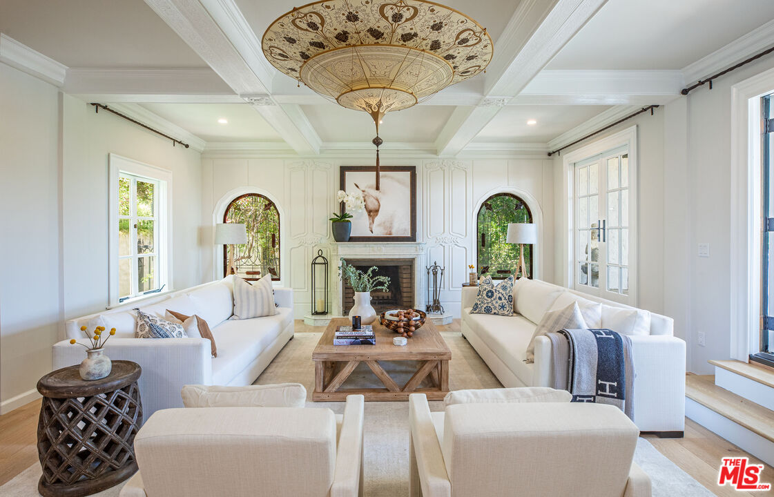 1756 Correa Way Los Angeles, CA 90049 - Photo 3 of 38 a living room with furniture a chandelier and a large window