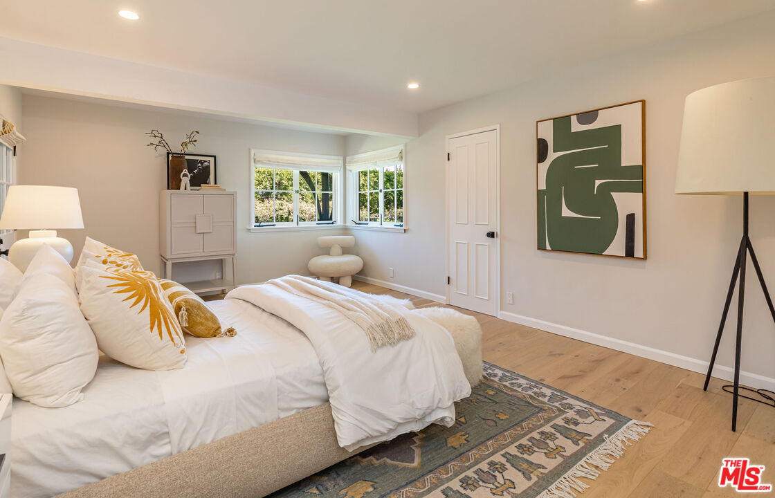 1756 Correa Way Los Angeles, CA 90049 - Photo 33 of 38 a bedroom with a bed and a painting on the wall