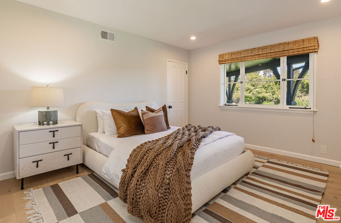 1756 Correa Way Los Angeles, CA 90049 - Photo 35 of 38 a bedroom with a bed and a window