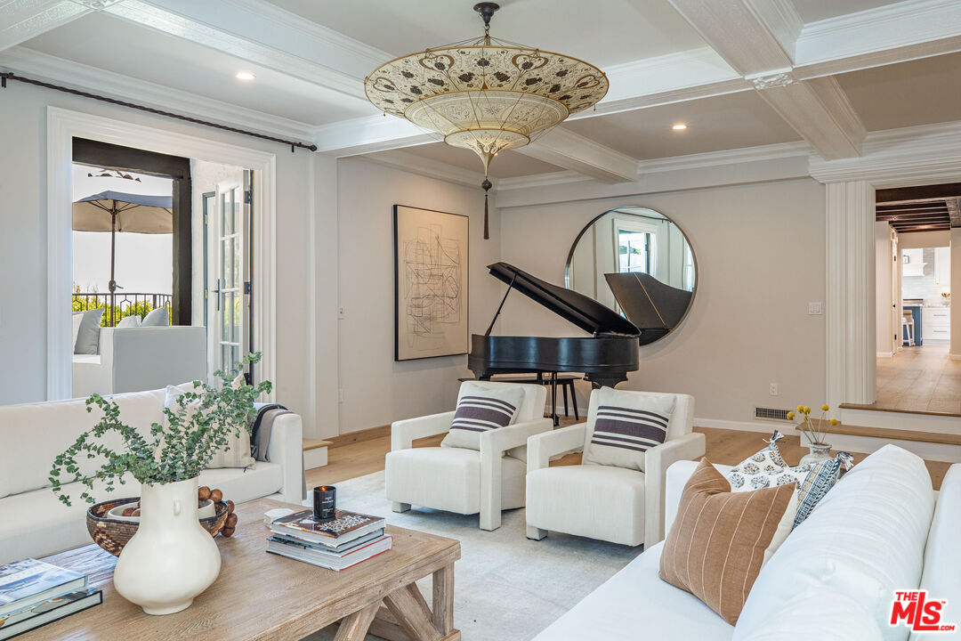 1756 Correa Way Los Angeles, CA 90049 - Photo 4 of 38 a living room with furniture a chandelier and a chandelier