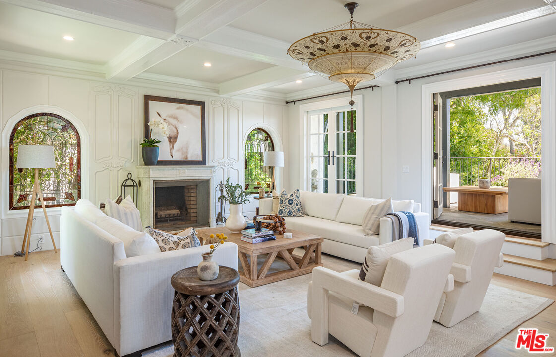 1756 Correa Way Los Angeles, CA 90049 - Photo 6 of 38 a living room with furniture a fireplace and a large window