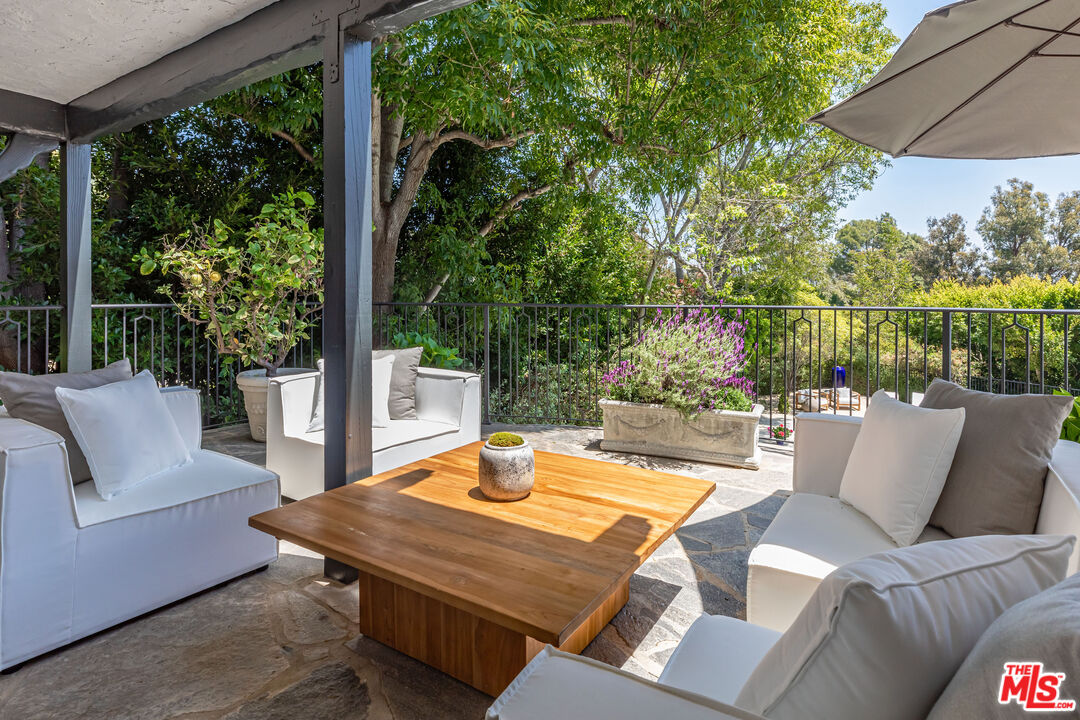 1756 Correa Way Los Angeles, CA 90049 - Photo 7 of 38 a view of a patio with couches table and chairs and potted plants