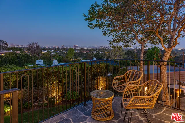 a view of a chair and table on the deck