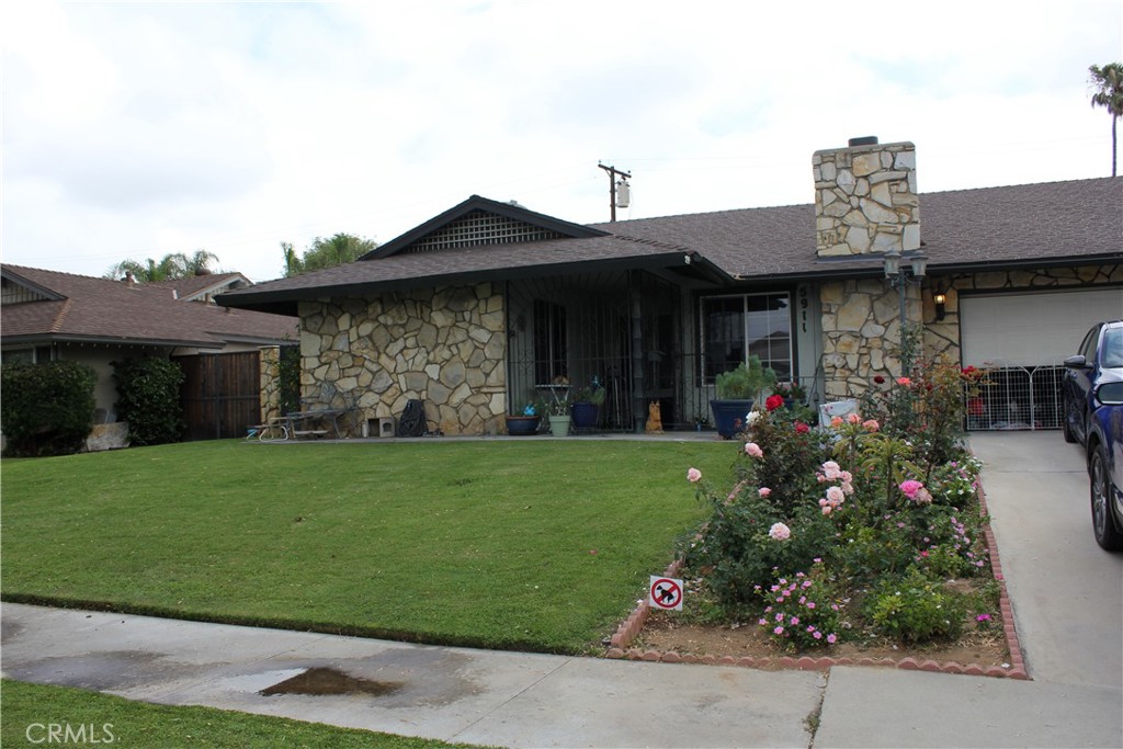 5911 Green Valley Road Riverside, CA 92504 - Photo 2 of 24 a front view of a house with a garden