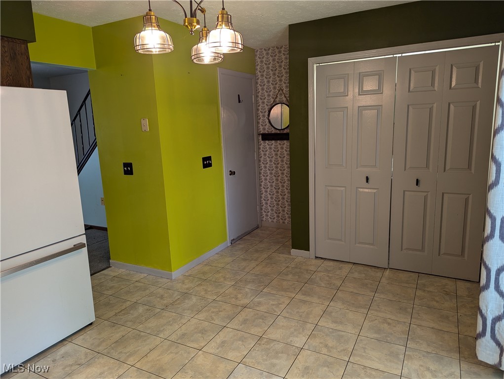 2500 Cleveland Road, Unit 202 Wooster, OH 44691 - Photo 6 of 22 Tiled dining room with an inviting chandelier