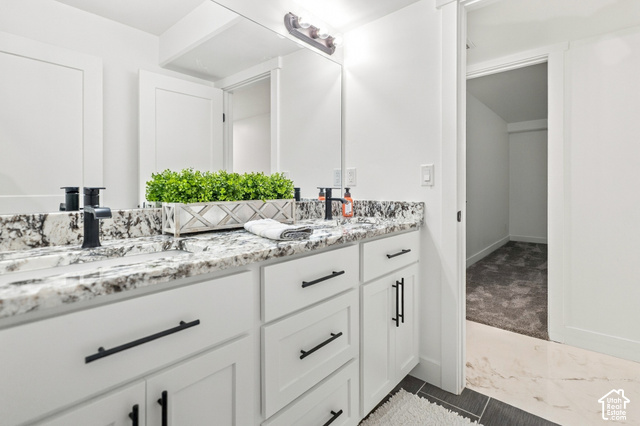 244 East Sevier River Road Central Valley, UT 84754 - Photo 58 of 66 Dual vanity with white cabinetry, black hardware, and speckled countertops