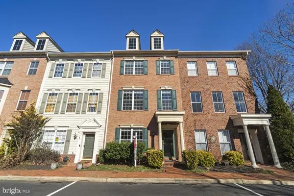 a front view of a residential apartment building with a yard