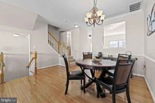 a view of a dining room with furniture and a chandelier