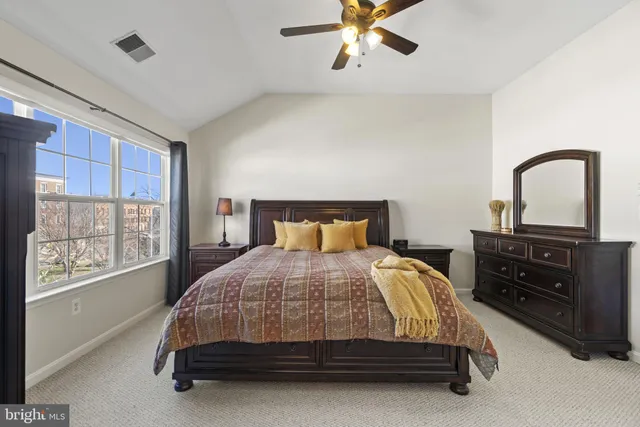 a bedroom with a bed and window with mirror