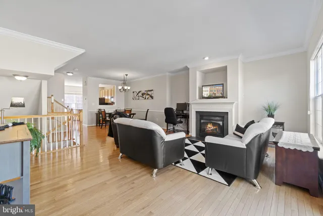 a living room with furniture wooden floor and a fireplace