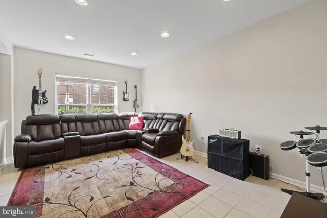 a living room with furniture a rug and a window