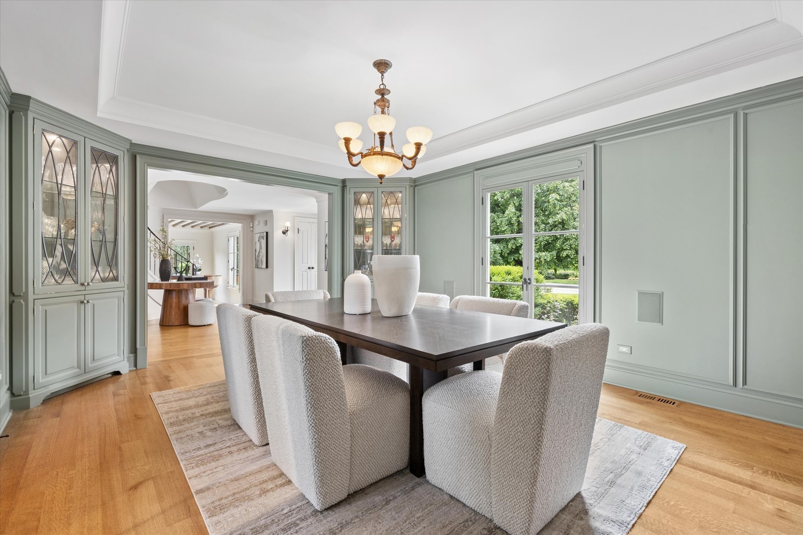 325 Princeton Road Hinsdale, IL 60521 - Photo 8 of 55 a dining room with wooden floor a chandelier a wooden table and chairs