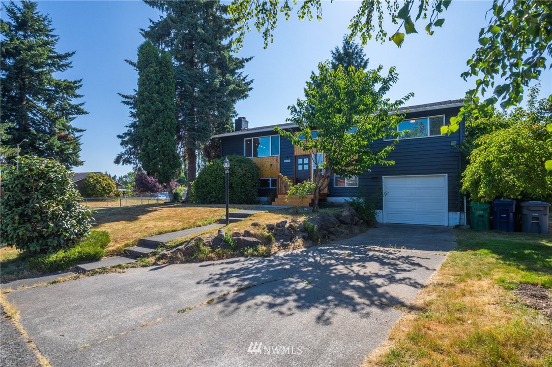 16504 124th Avenue Southeast Renton, WA 98058 - Photo 29 of 29 a view of a house with backyard and tree