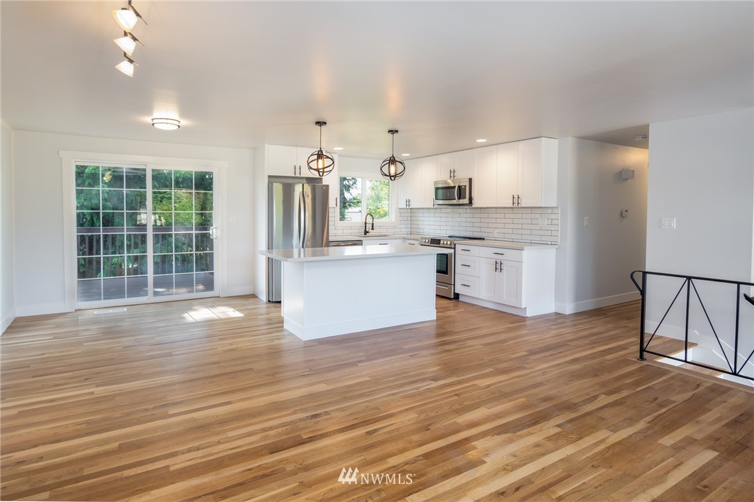 16504 124th Avenue Southeast Renton, WA 98058 - Photo 6 of 29 a view of kitchen with granite countertop cabinets and wooden floor