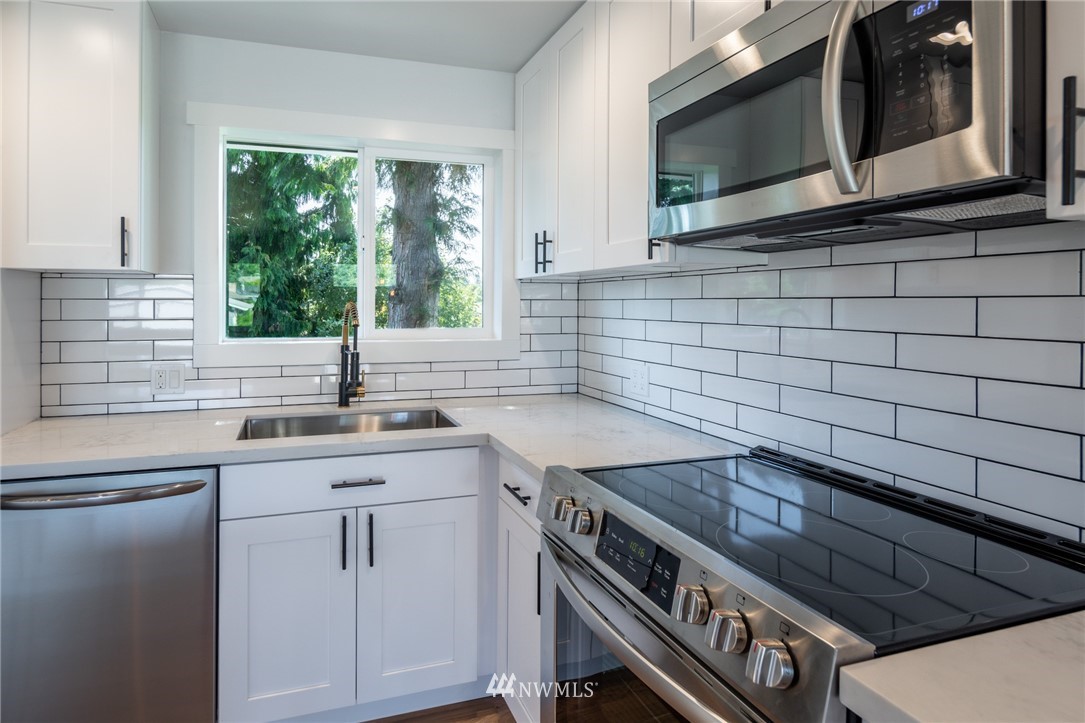 16504 124th Avenue Southeast Renton, WA 98058 - Photo 9 of 29 a kitchen with a stove microwave and sink