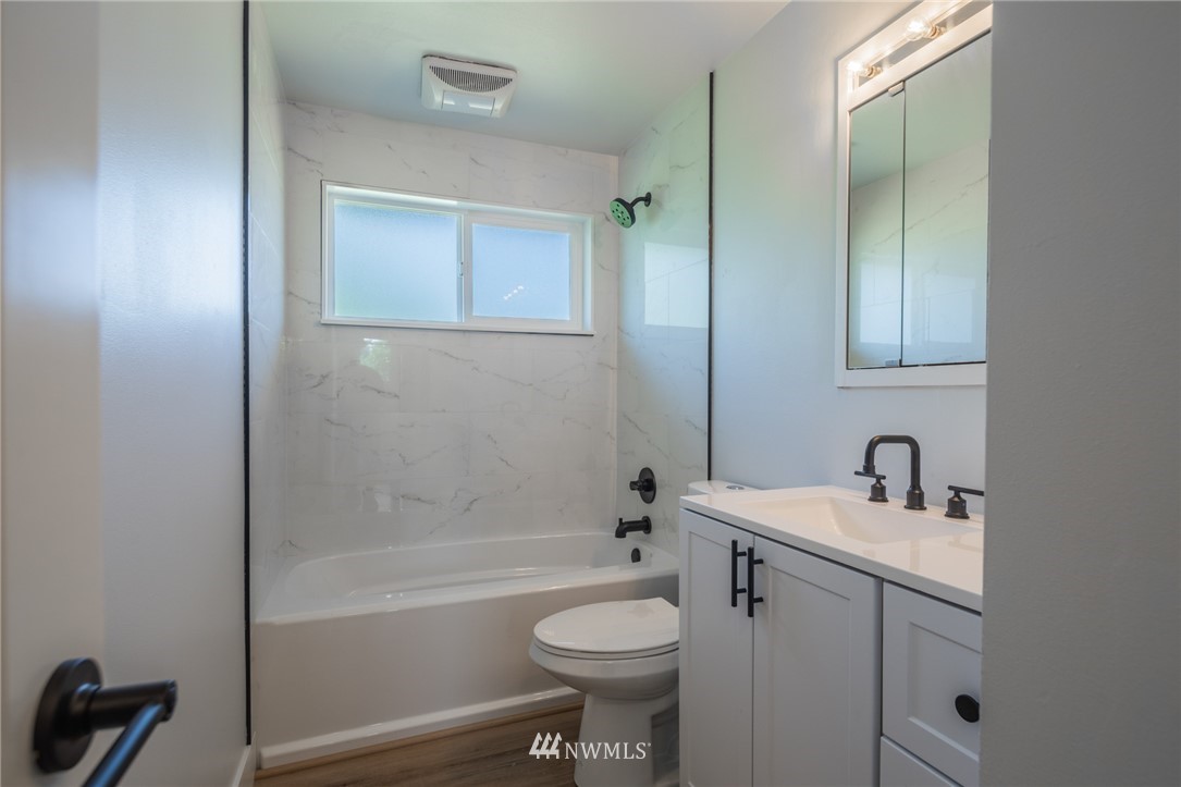 16504 124th Avenue Southeast Renton, WA 98058 - Photo 10 of 29 a bathroom with a sink a toilet and shower