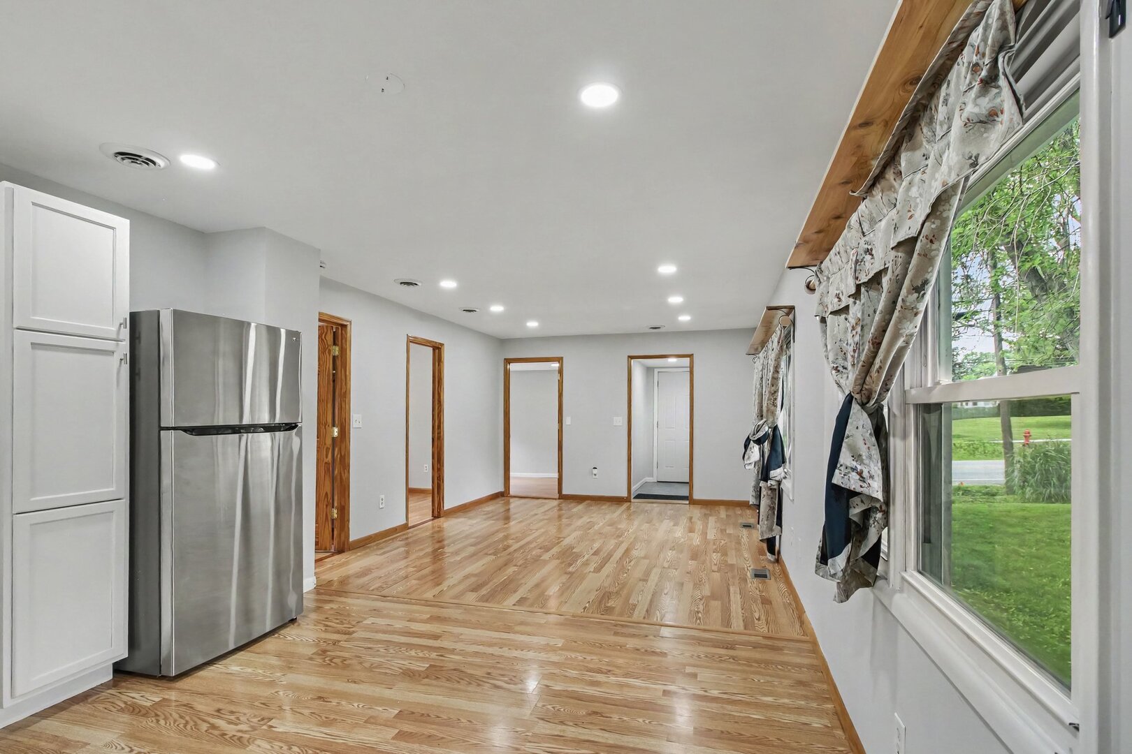 208 West Nippersink Road Round Lake, IL 60073 - Photo 4 of 18 a view of an entryway with wooden floor stairs and a livingroom view