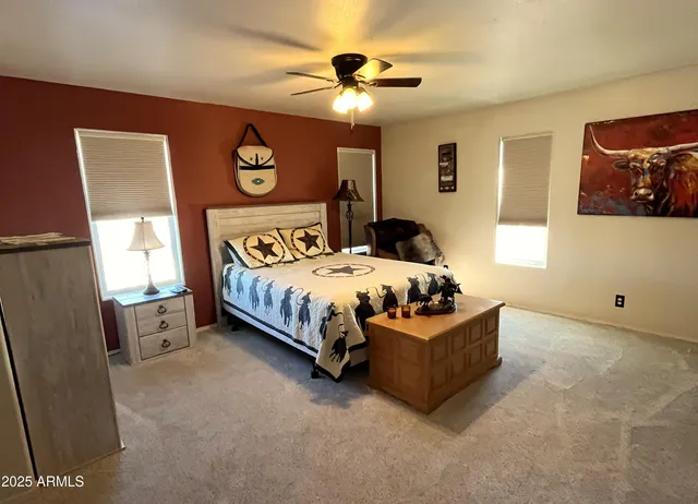 a bedroom with a bed and a chandelier