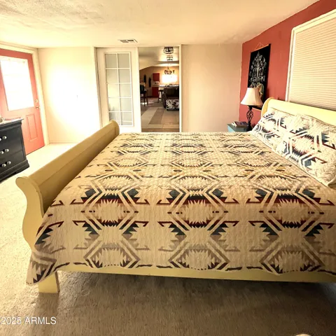 a bedroom with a bed and a view of bedroom