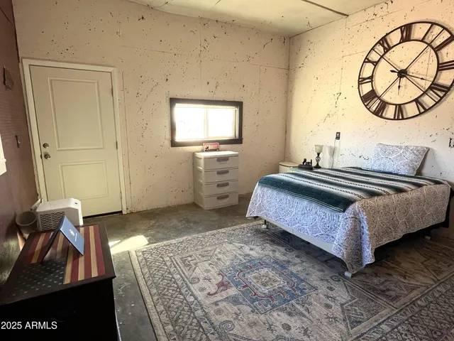 a bedroom with a bed and chandelier