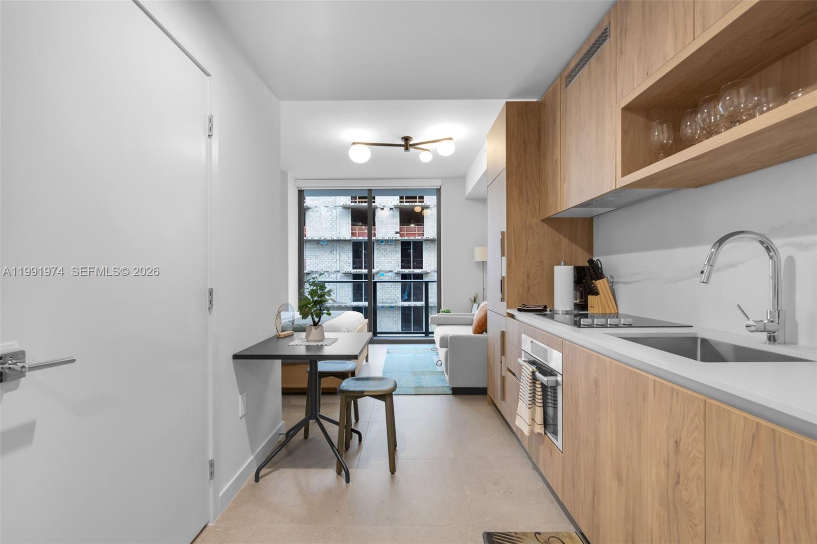 a view of a kitchen with a sink and cabinets